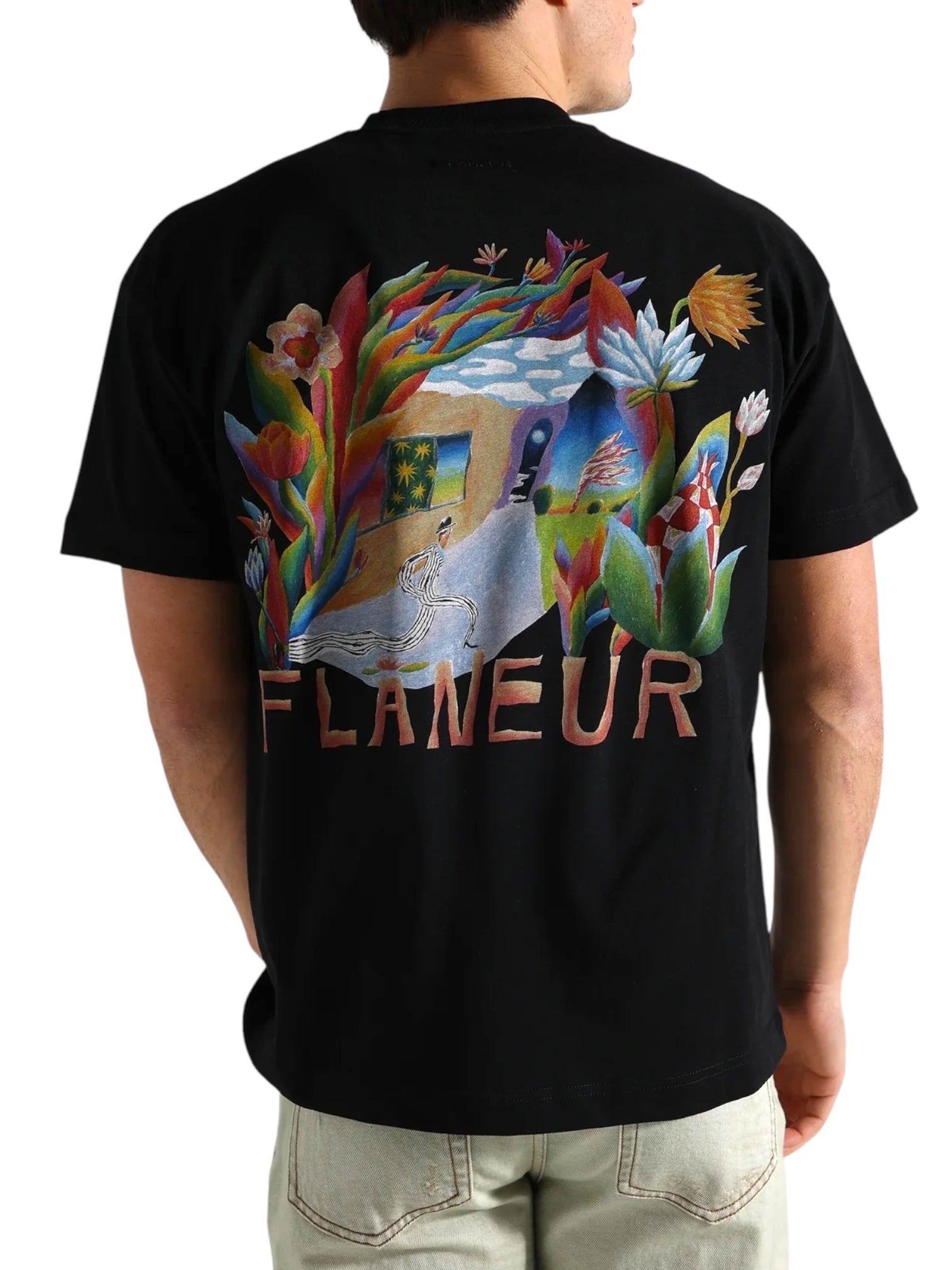 Someone wearing the FLANEUR Passage of Time T-Shirt Black, featuring colorful artwork and "FLANEUR" printed on the back.