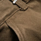 Close-up of army green corduroy fabric featuring a "FLANEUR" label attached to a belt loop, showcasing the cotton texture of the Flaneur Phone Pocket Cargo Trousers.