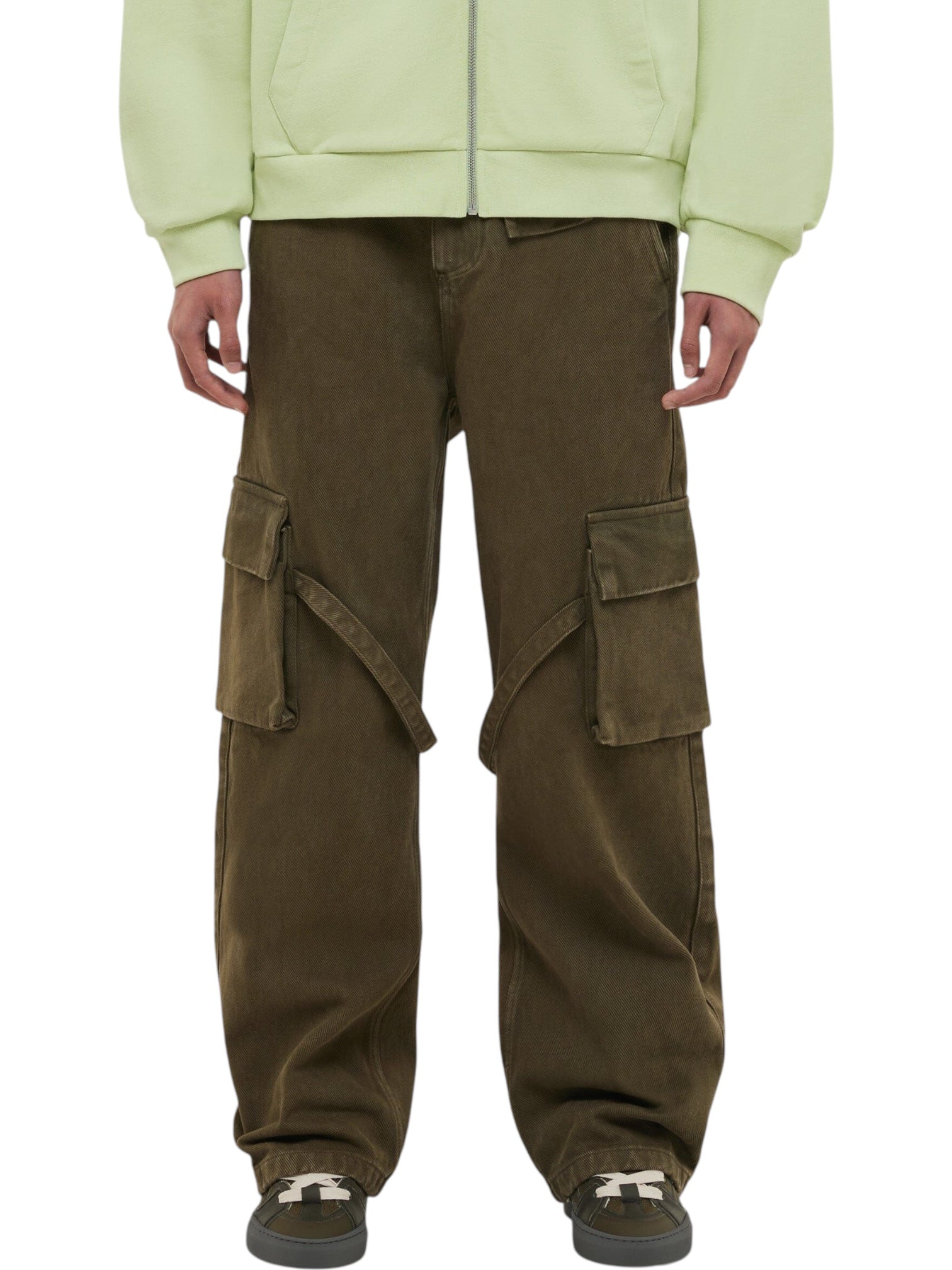 Person is wearing FLANEUR Flaneur Phone Pocket Cargo Trousers in Army Green with large side pockets and adjustable tabs, paired with gray sneakers and a light green hoodie. The image captures the outfit from shoulders down.