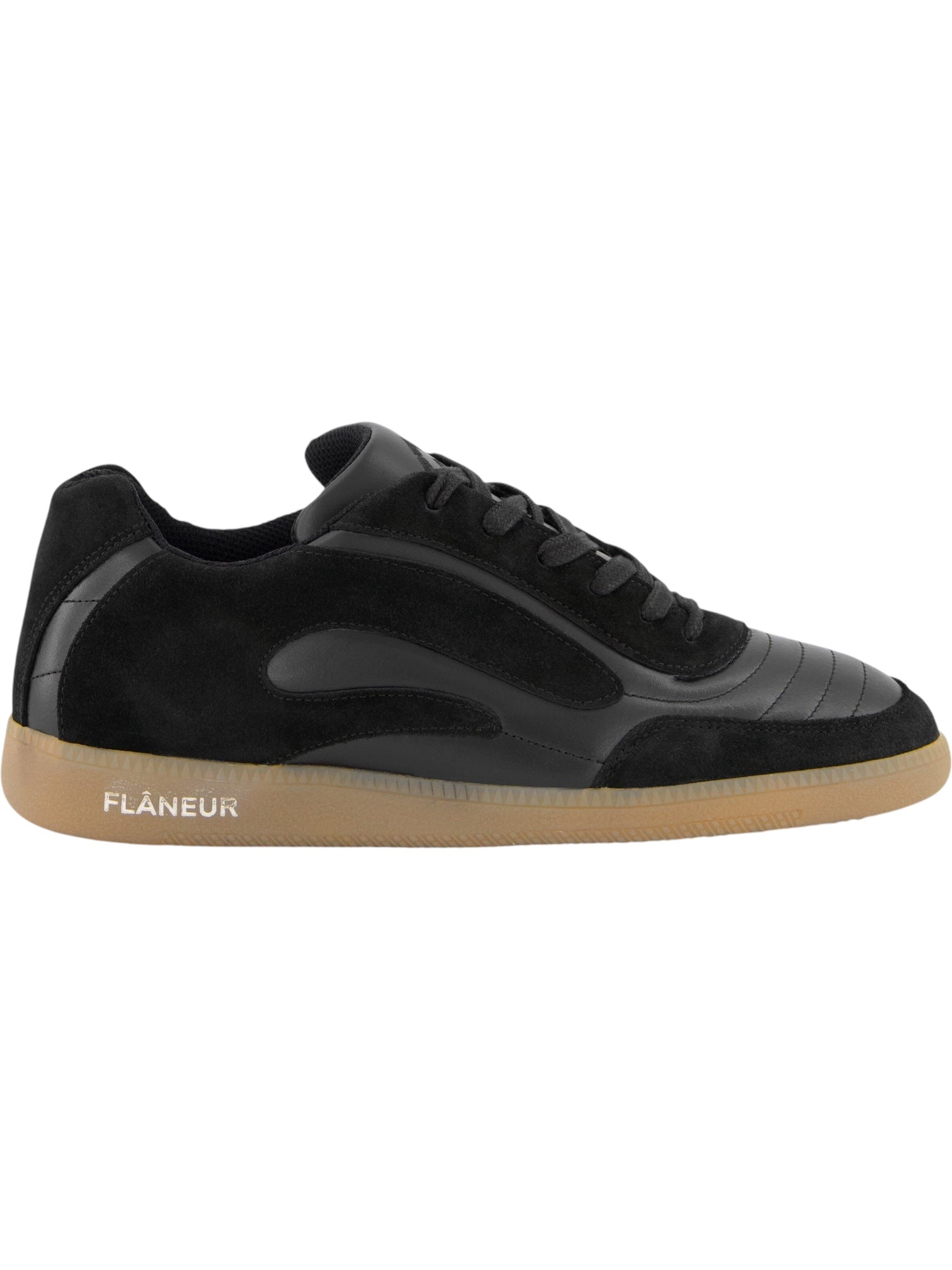 The FLANEUR Tivoli Runner Black is a luxury low-top sneaker featuring black suede and calfskin leather panels, black laces, a light brown gum sole, and "FLÂNEUR" branding on the outer heel.
