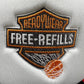 A close-up of the FREE REFILLS Free Refills Harley Trucker (FR-C3-39) in White/Black, featuring a white fabric patch with "READYWEAR FREE-REFILLS" in orange and white text and an orange basketball, echoing classic trucker hat style.