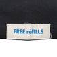 The FREE REFILLS Free Refills Romance Tee (FR-C3-12) in vintage black features a white fabric label with blue "FREE reFILLS" text sewn onto heavyweight cotton, offering a true-to-size fit.
