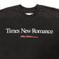 The FREE REFILLS Free Refills Romance Tee (FR-C3-12) is a vintage black heavyweight cotton T-shirt featuring "Times New Romance" in bold white and "FREE FILLS READYWEAR" in red; true to size fit.