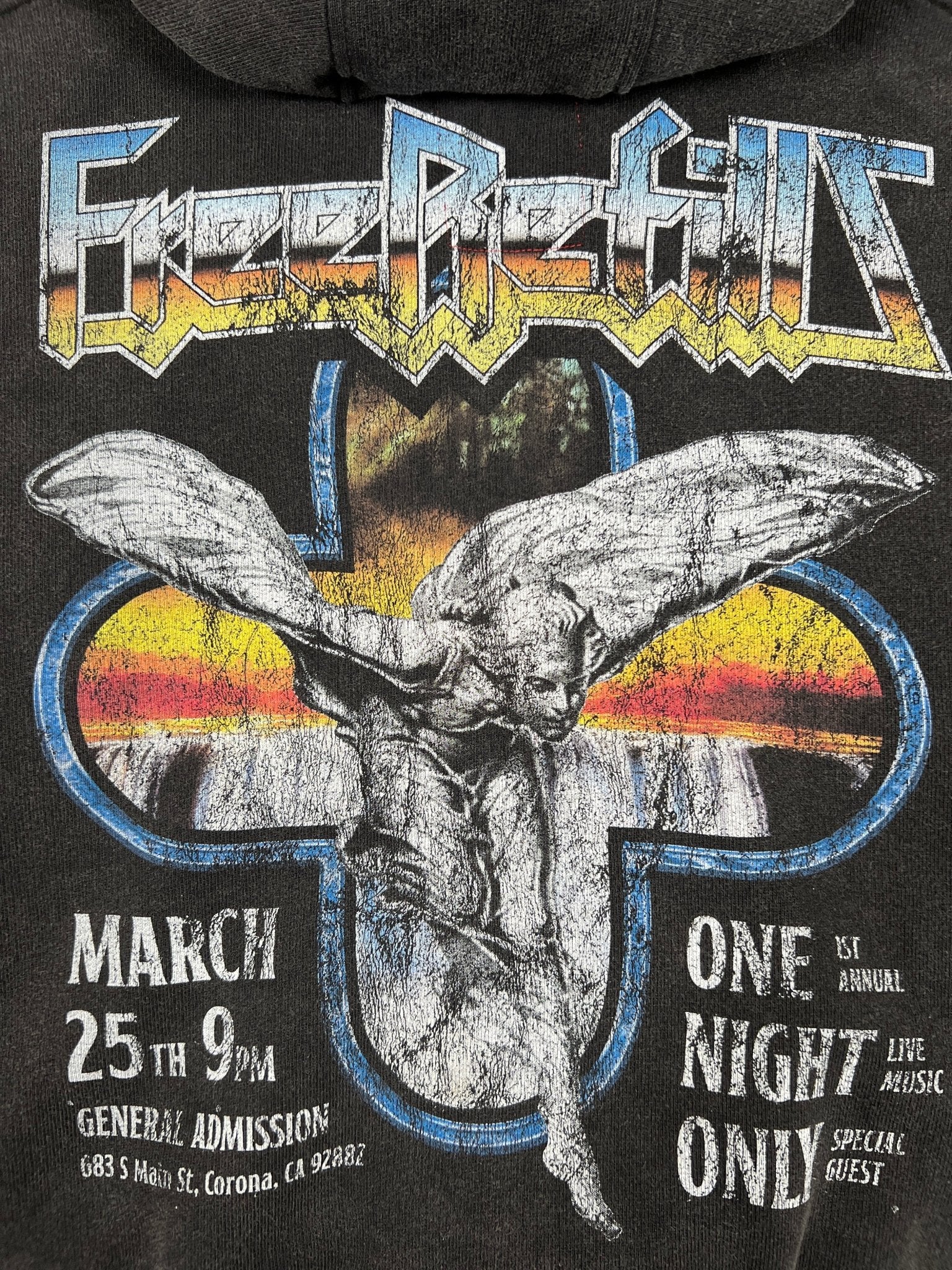 A promo graphic for the FREE REFILLS Free Refills Showcase Hoodie (FR-C3-27) in Vintage Black, featuring an angel statue, event details, and colorful text on a dark background with a retro fade wash effect.