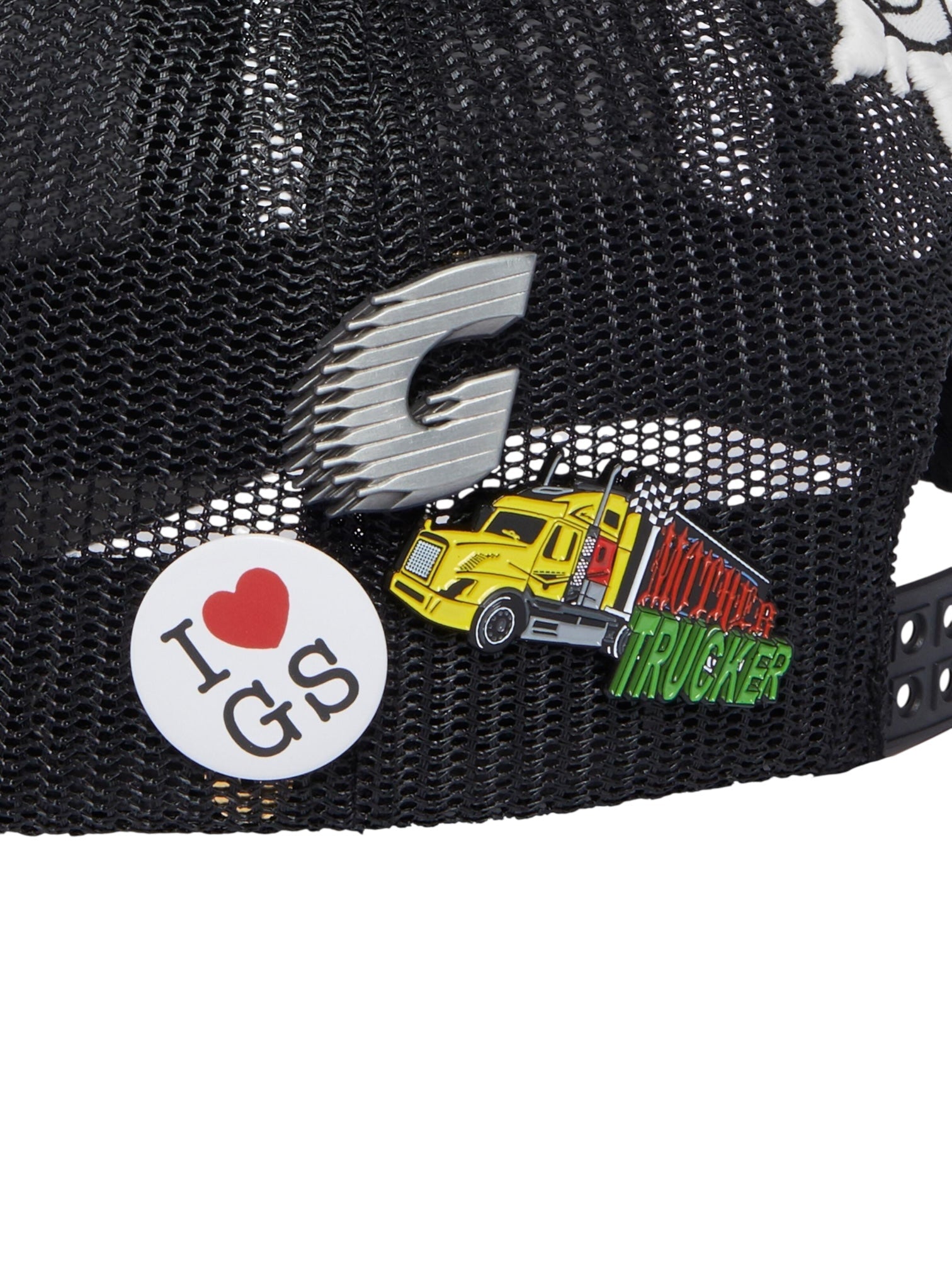The GODSPEED Gs Forever Hat Black features black mesh and comes with three pins: a silver "G," a white "I ♥ GS" badge, and a yellow truck reading "Midwest Trucker." This limited edition accessory adds standout style.