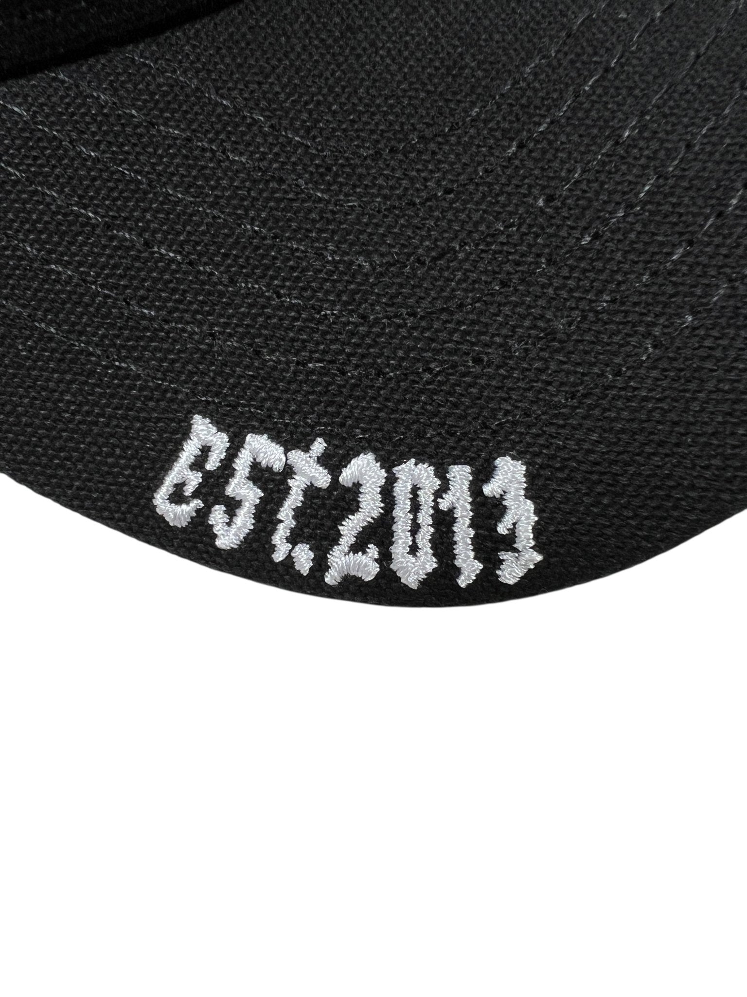 Close-up of the GODSPEED Godspeed GS Forever Trucker Gradient Hat Hawaiian, a limited edition black hat with white "EST. 2013" embroidery.