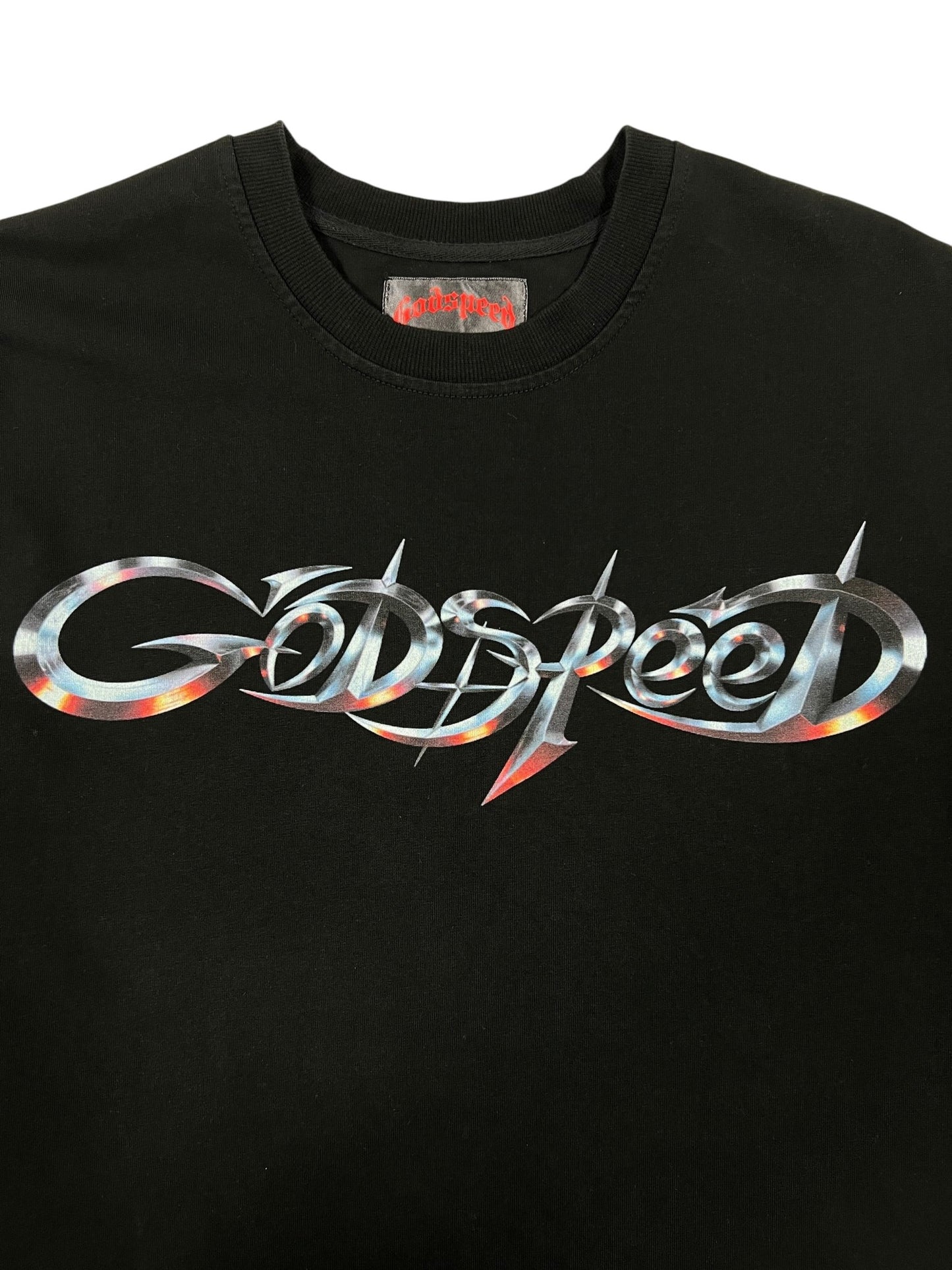 The GODSPEED Godspeed New Age Logo T-Shirt Black features a metallic spiked "Godspeed" graphic on the front and a matching logo printed on the inner neck label.