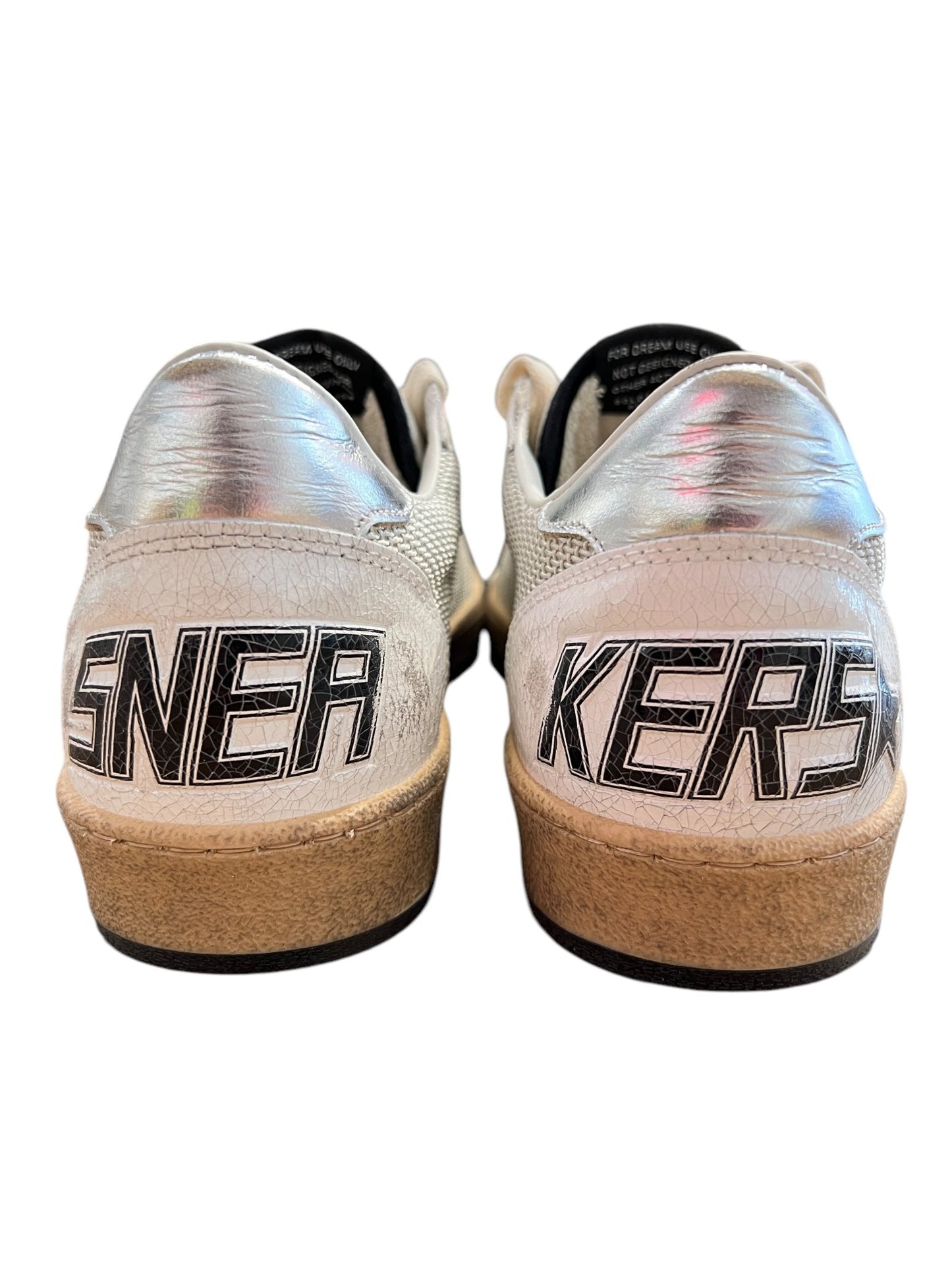 The Golden Goose GMF00117 Ball Star sneakers showcase metallic accents, a black leather star, and "SNER" on the left shoe with "KERS" on the right heel. Finished with a durable rubber sole, these stylish shoes are presented against a plain background. Brand: GOLDEN GOOSE.