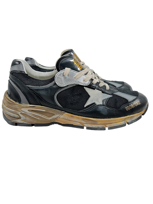 Pair of GOLDEN GOOSE GMF00199 RUNNING DAD STAR BLACK/SILVER/ICE sneakers with a white star logo, gold-tone sole details, and the word "Golden" printed on the side from Golden Goose.