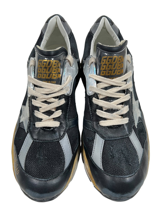 A pair of GOLDEN GOOSE GMF00199 RUNNING DAD STAR BLACK/SILVER/ICE sneakers with white laces. The tongue of each shoe has text reading "GGB CLUB." Perfect as Running Dad Sneakers, these Golden Goose shoes feature a star logo on the sides.