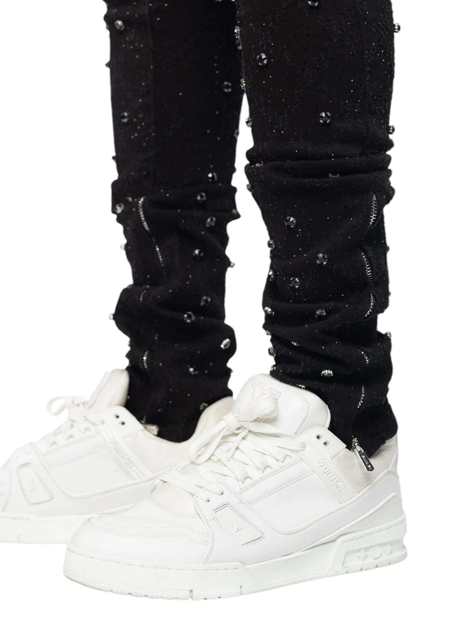 White sneakers paired with GUAPI's ALL BLACK EMBELLISHED DENIM in a tapered fit.