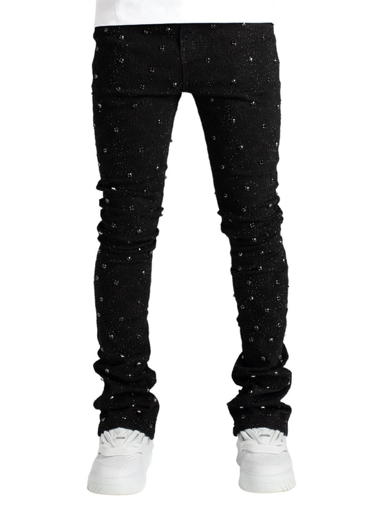Person wearing black, GUAPI ALL BLACK EMBELLISHED DENIM with diamond embellishments and white sneakers, standing with legs slightly apart against a white background.