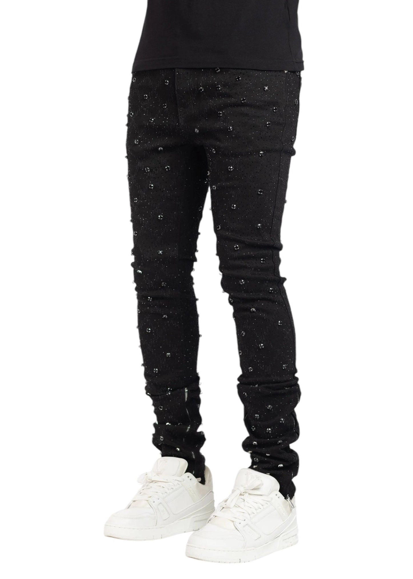 Individual in GUAPI ALL BLACK EMBELLISHED DENIM and white sneakers.