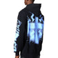 A person wears the GUAPI Guapi Black Revived Hoodie V2 featuring blue electric graphics on the back and sleeve, standing against a white background.