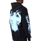 A person wearing the GUAPI Guapi Black Revived Hoodie V2, a streetwear hoodie with a bold blue and white lightning design and geometric graphic on the back, viewed from behind.