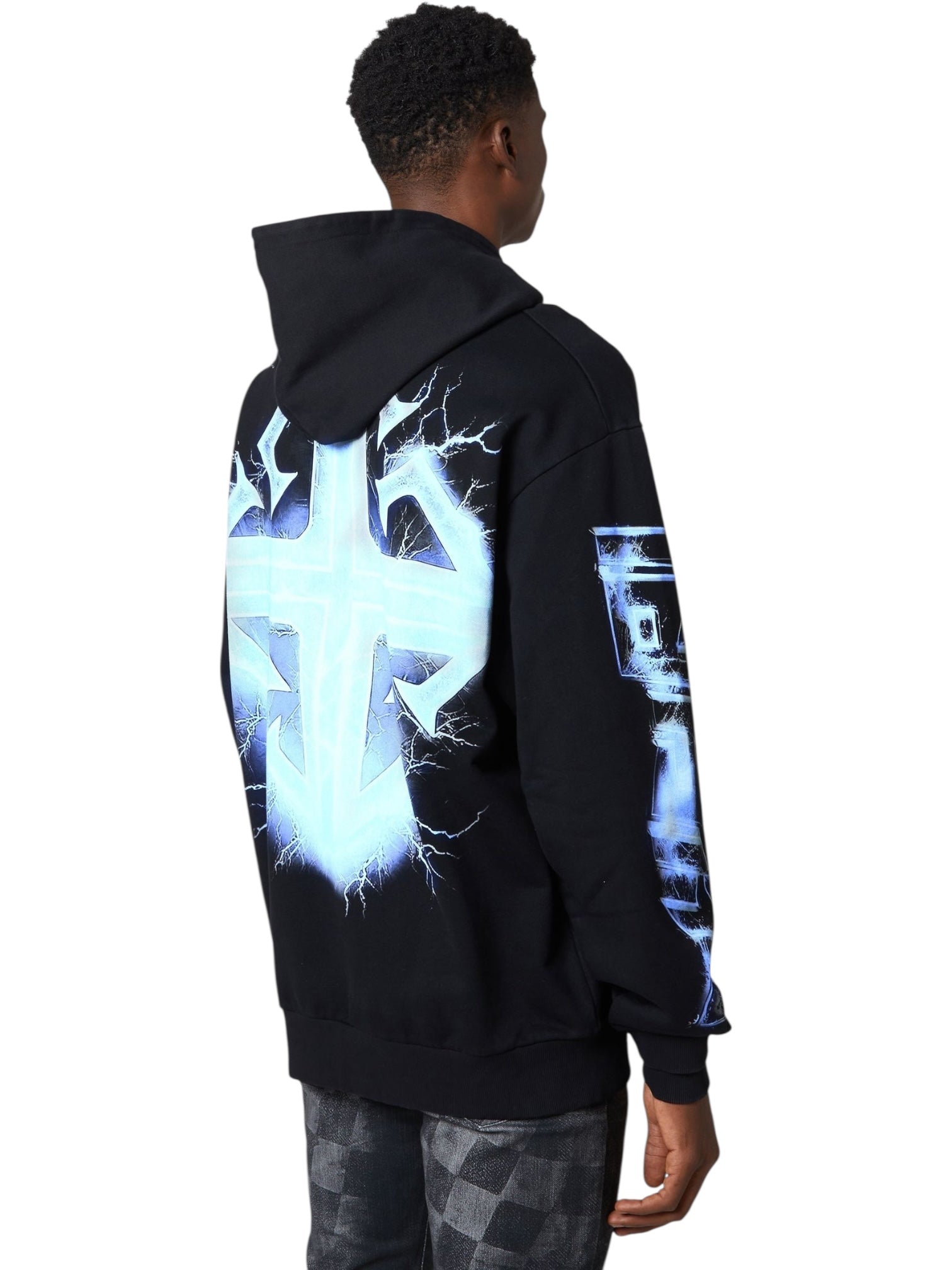 A person wearing the GUAPI Guapi Black Revived Hoodie V2, a streetwear hoodie with a bold blue and white lightning design and geometric graphic on the back, viewed from behind.