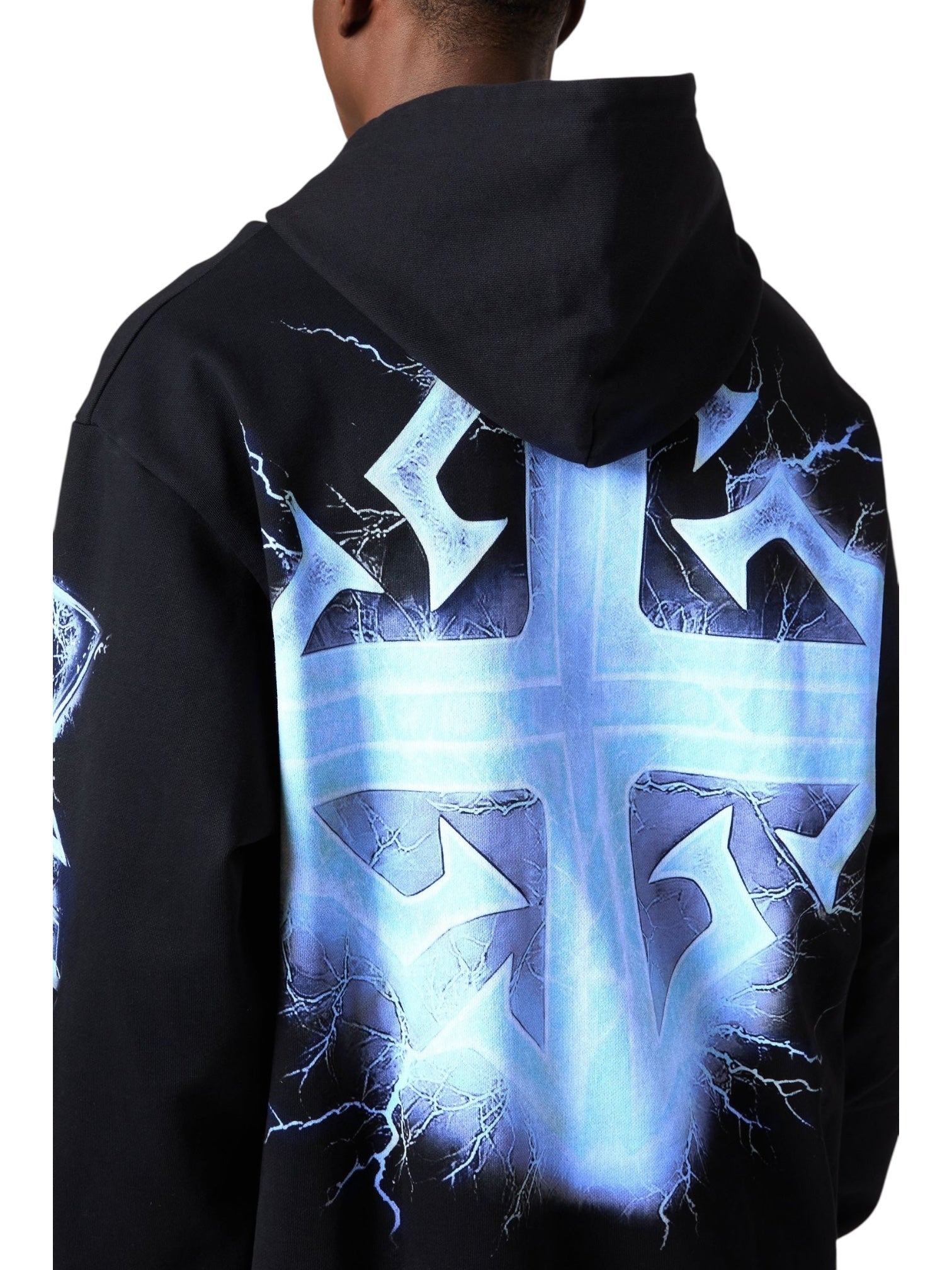 Person wearing the GUAPI Guapi Black Revived Hoodie V2, a streetwear piece featuring a bold blue lightning cross graphic with striking lightning patterns on the back and sleeve.