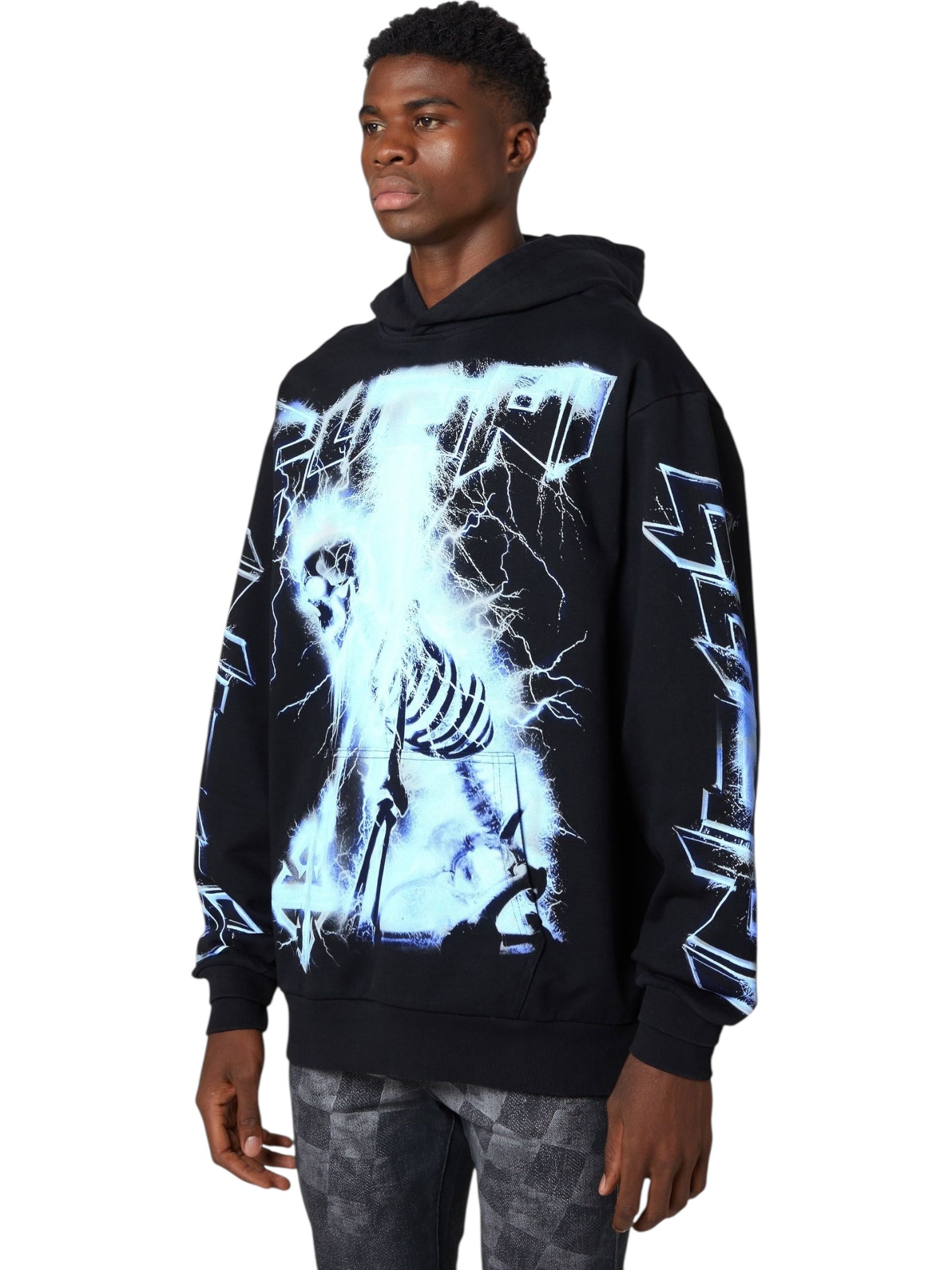 A man wears the GUAPI Guapi Black Revived Hoodie V2 with blue lightning and skeleton graphics on the front and sleeves, standing against a white background.