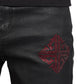 Close-up of GUAPI's limited edition Obsidian Black Icon Embellished Denim V2, showcasing a red, studded geometric pattern on the thigh.