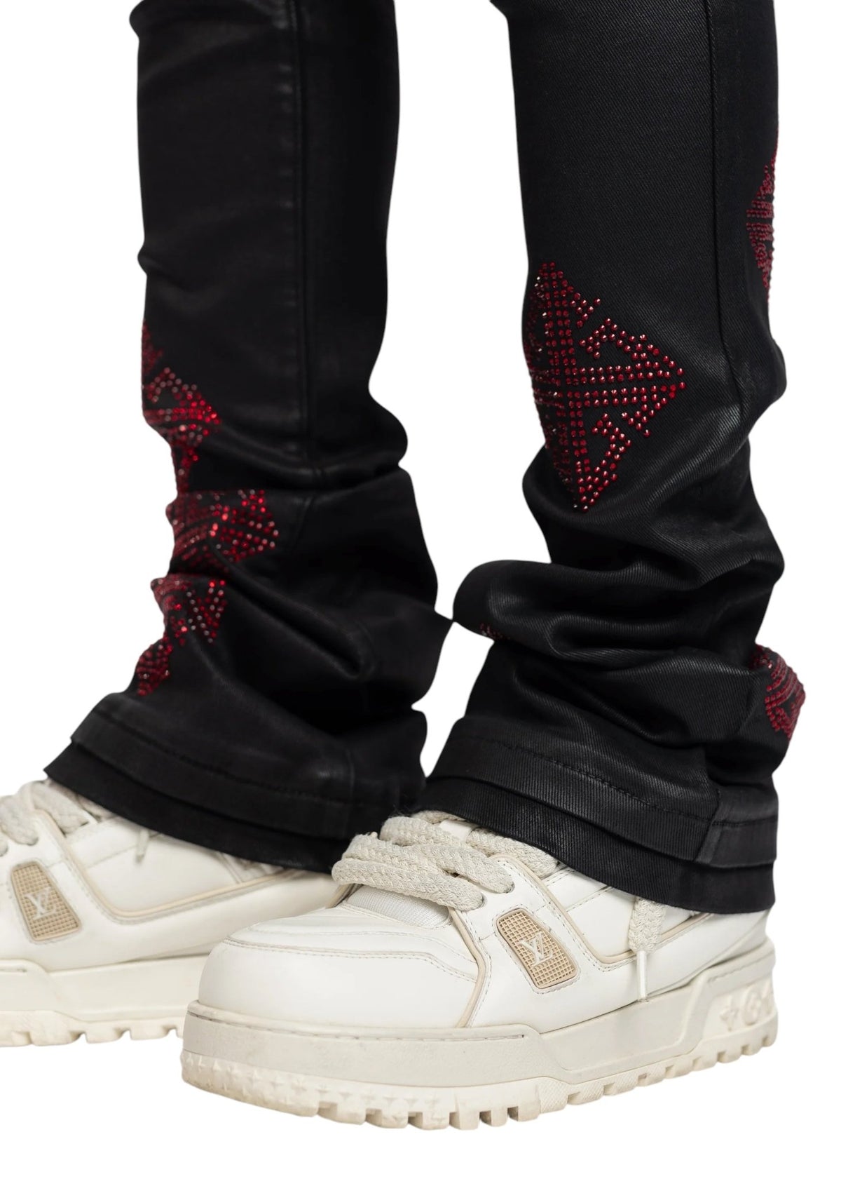 A person wearing GUAPI's Obsidian Black Icon Embellished Denim V2 with white sneakers.