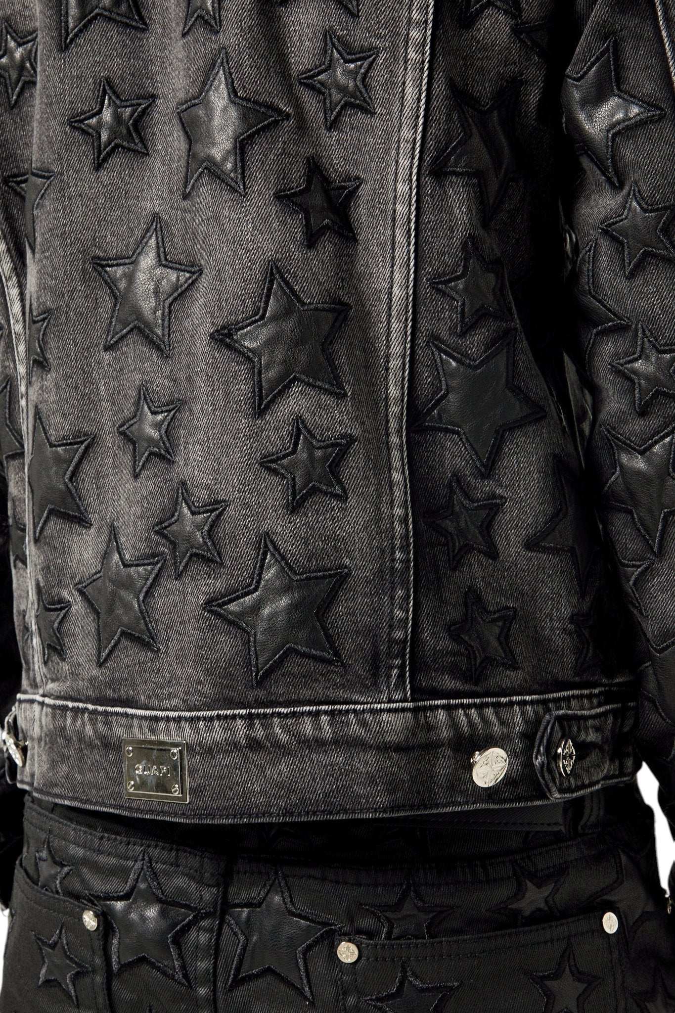 The GUAPI Obsidian Black Stars Denim Jacket, embossed with star patterns, is ideal for edgy streetwear enthusiasts and pairs perfectly with matching pants.