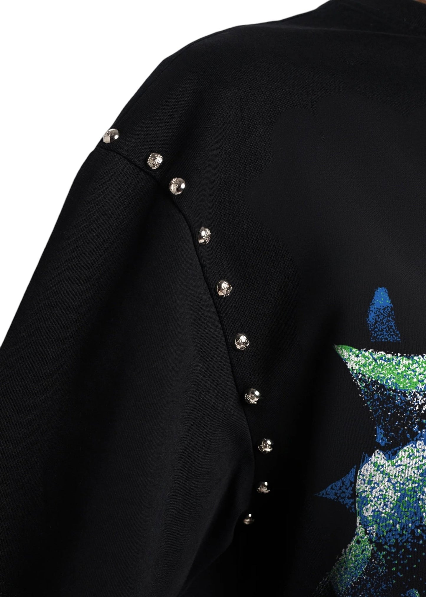 Close-up of the Guapi skull cracker tee black by GUAPI, showcasing metallic studs along the seam and a green and blue abstract design inspired by a skull cracker motif.