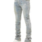Person wearing GUAPI Guapi Vintage Blue Distressed Cross Denim jeans with chain detail, white sneakers, and a white top, shown from the waist down.