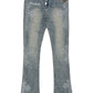The GUAPI Vintage Blue Distressed Cross Denim jeans feature rhinestone embellishments, white "GUAPI" text on the left hip and right ankle, plus a silver chain attached to the waistband.