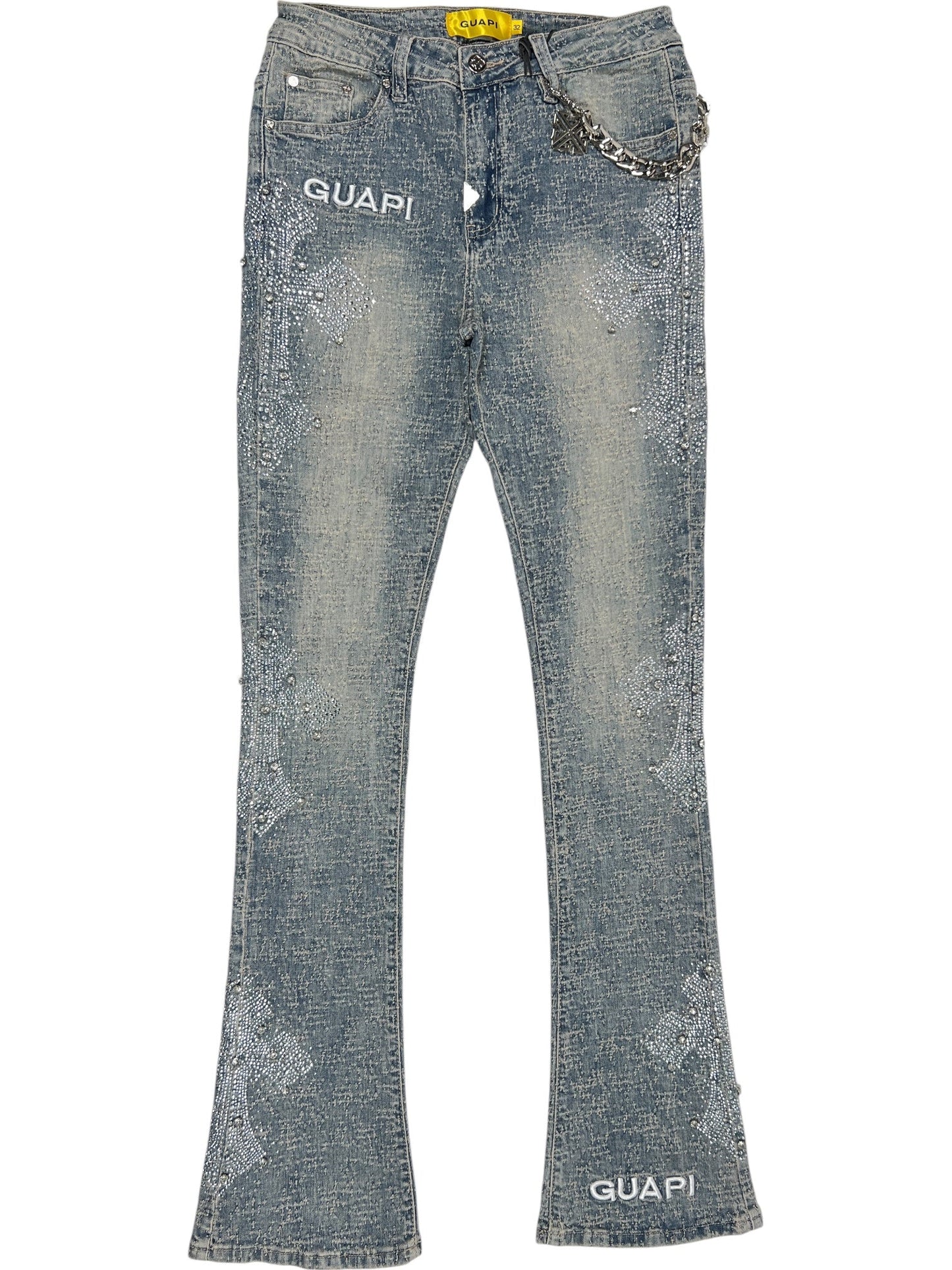 The GUAPI Vintage Blue Distressed Cross Denim jeans feature rhinestone embellishments, white "GUAPI" text on the left hip and right ankle, plus a silver chain attached to the waistband.