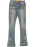 The GUAPI Vintage Blue Distressed Cross Denim jeans feature rhinestone embellishments, white "GUAPI" text on the left hip and right ankle, plus a silver chain attached to the waistband.