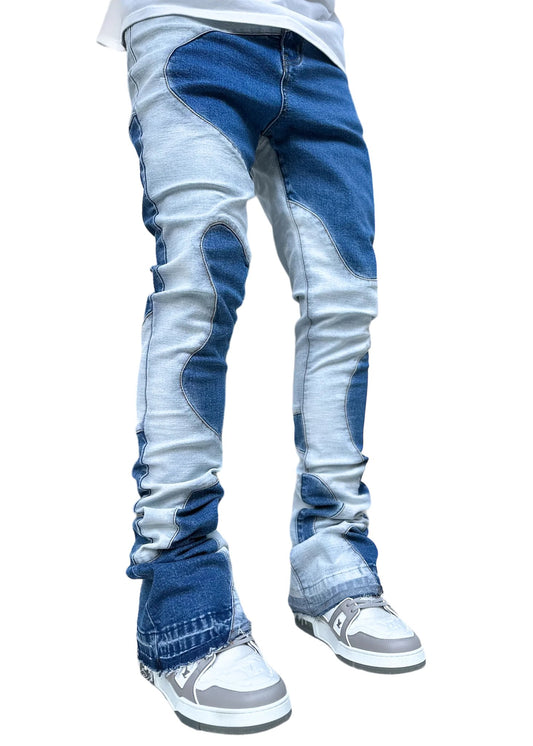A person standing in GUAPI vintage blue wavy denim jeans and white sneakers.