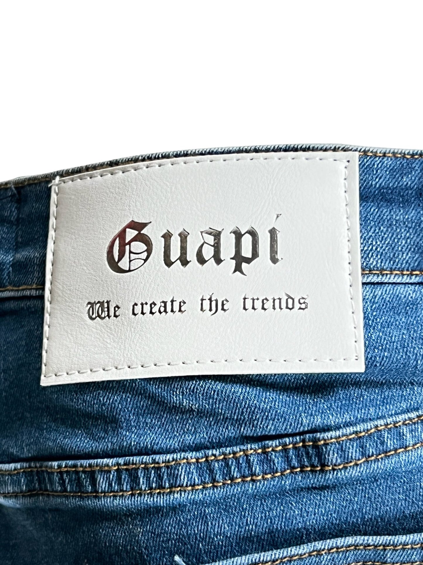 GUAPI VINTAGE BLUE WAVY DENIM with "guapi we create the trends" text on stretch denim fabric.