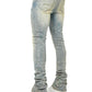 Person wearing GUAPI Vintage Olive Pearls Denim jeans with white paint splatter, paired with chunky white sneakers, shown from the back.