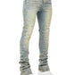A person wearing GUAPI Guapi Vintage Olive Pearls Denim, featuring light wash skinny stacked jeans with scattered rhinestone embellishments, paired with white chunky sneakers. Only the lower torso and legs are visible against a plain background.