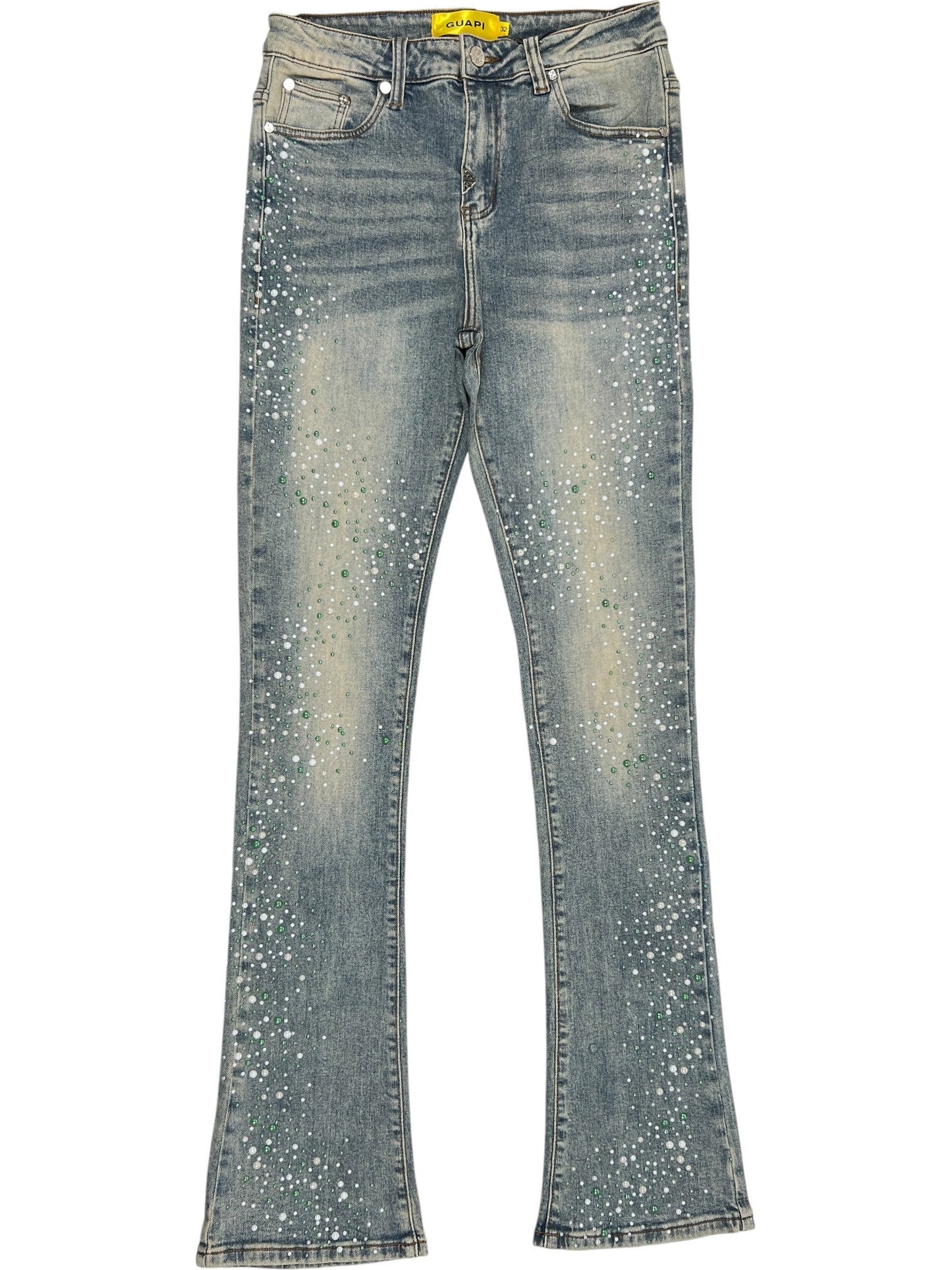 A pair of GUAPI Guapi Vintage Olive Pearls Denim jeans with a flared cut, faded wash, and white and green paint splatter details on the front legs.