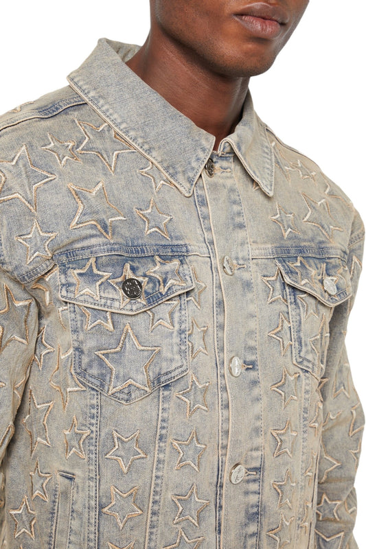 A person wearing the Guapi Vintage Stars Denim Jacket by GUAPI, featuring a charming star embroidery design.