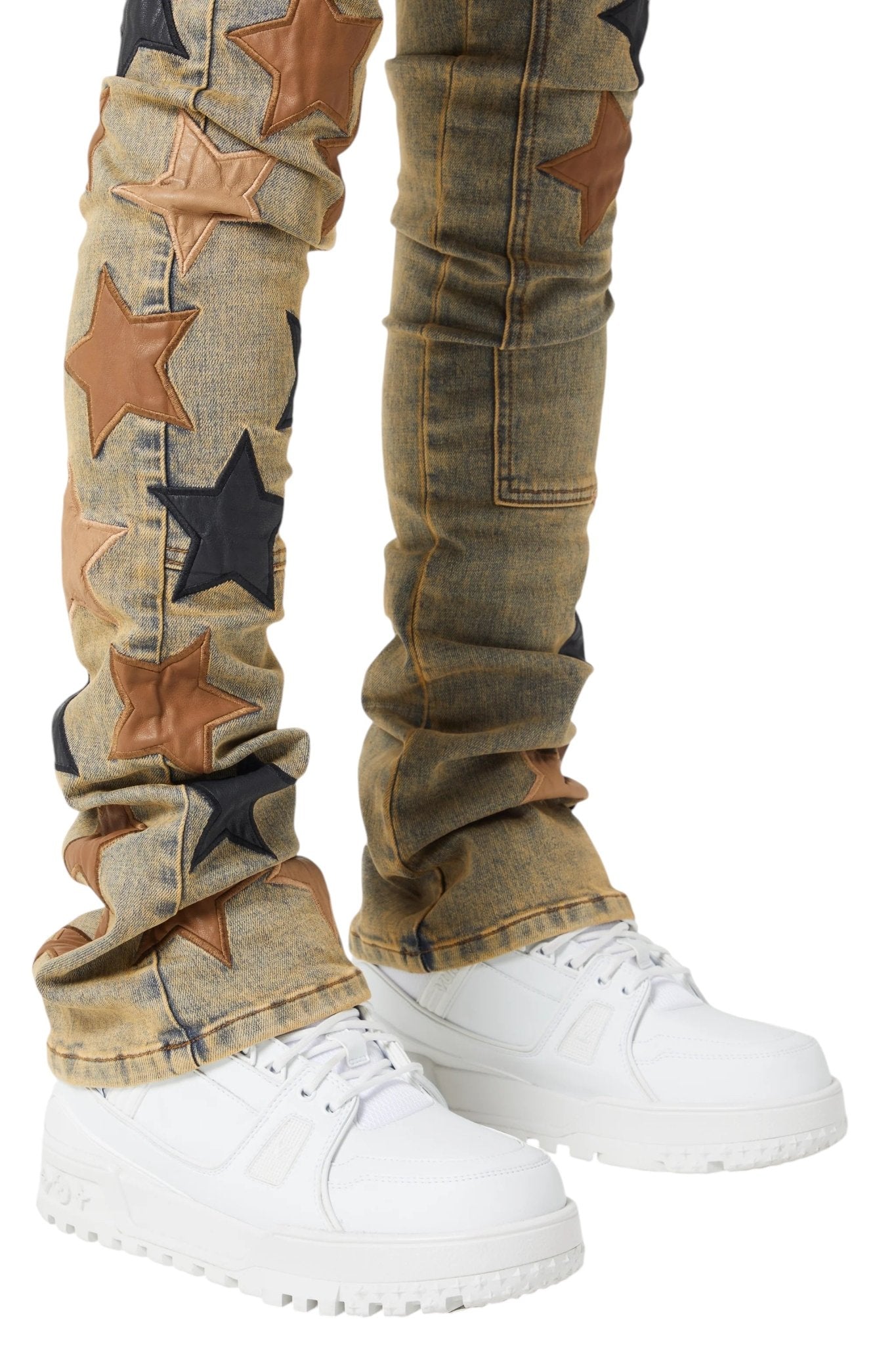 The Guapi Vintage Stars Denim V2 by GUAPI features black and brown premium leather star patches. Pair them with white sneakers for a charming look. Its slim fit and stacked hem add vintage flair to your wardrobe.