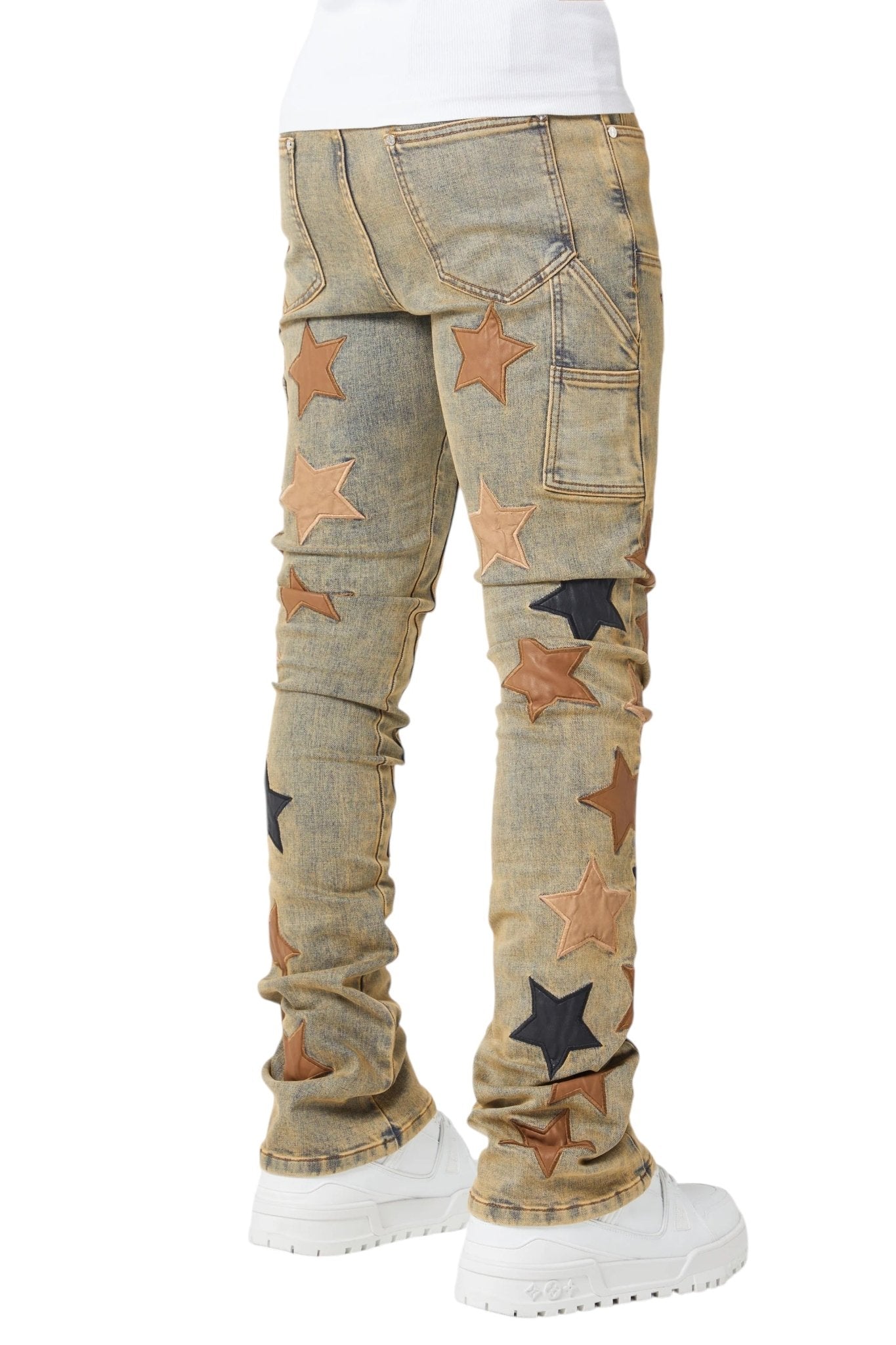 Rear view shows person in light brown jeans with GUAPI Vintage Stars Denim V2 patches, white shoes, and a white top.