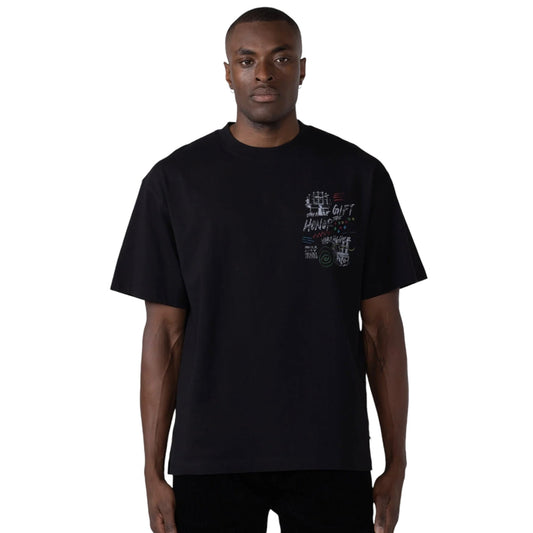 An individual wearing the Honor The Gift A-Spring Panel Htg Vibe Higher Ss Tee in black from HONOR THE GIFT, featuring a screen-printed graphic design on the front, stands against a plain background.