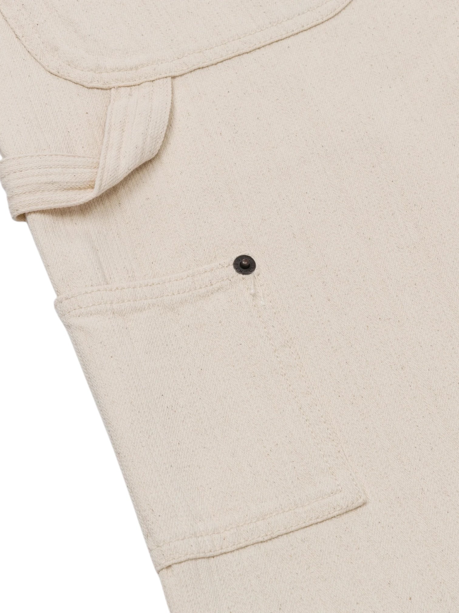 Close-up of the HONOR THE GIFT Gears Carpenter Short Cream, a beige 100% cotton short with classic twill styling, side fabric loop, black buttoned pocket, and a 13" inseam.