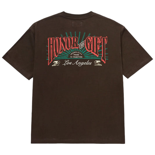 The Honor The Gift Htg Cigar Label Ss Tee in black is made from 100% cotton and showcases "Honor The Gift," "Los Angeles," and "Pride in Tradition" screen-printed on the back in vibrant red, green, and white.