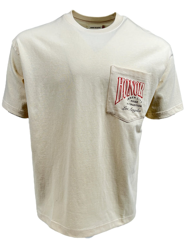 Introducing the HONOR THE GIFT HTG CIGAR LABEL SS TEE BONE by HONOR THE GIFT – a beige T-shirt crafted from 100% cotton. This tee boasts a front left breast pocket adorned with the word "HONOR" in striking red letters and additional text that reads "A Refined American Tradition, Los Angeles." Enjoy the lightweight comfort of this jersey, which brings to mind the vintage style of cigar labels.