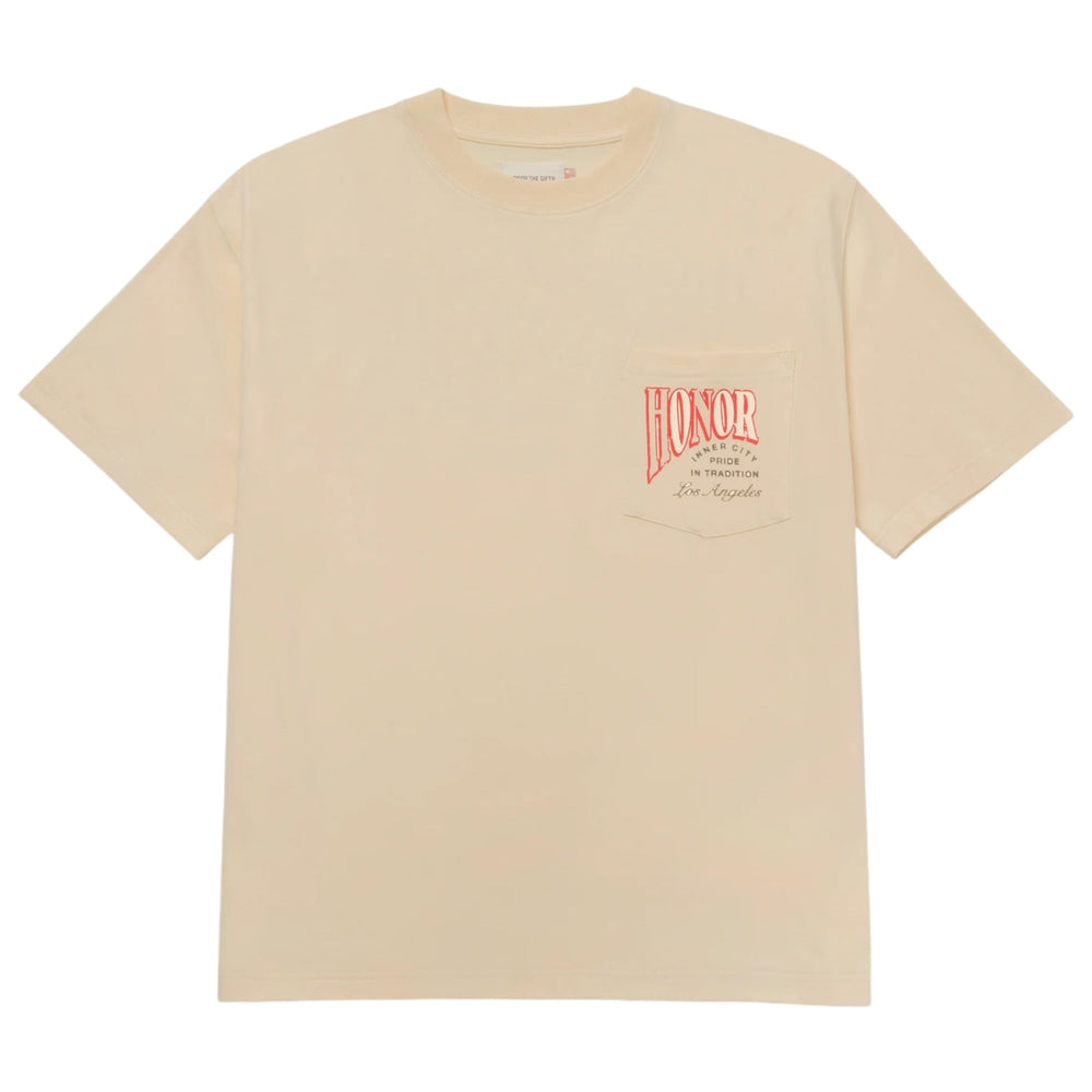 The Honor The Gift Htg Cigar Label Ss Tee in Bone showcases a classic beige design with bold red "HONOR" and "LOS ANGELES" lettering on the front pocket, reminiscent of a vintage cigar label. Made from 100% cotton, it ensures ultimate comfort and style.