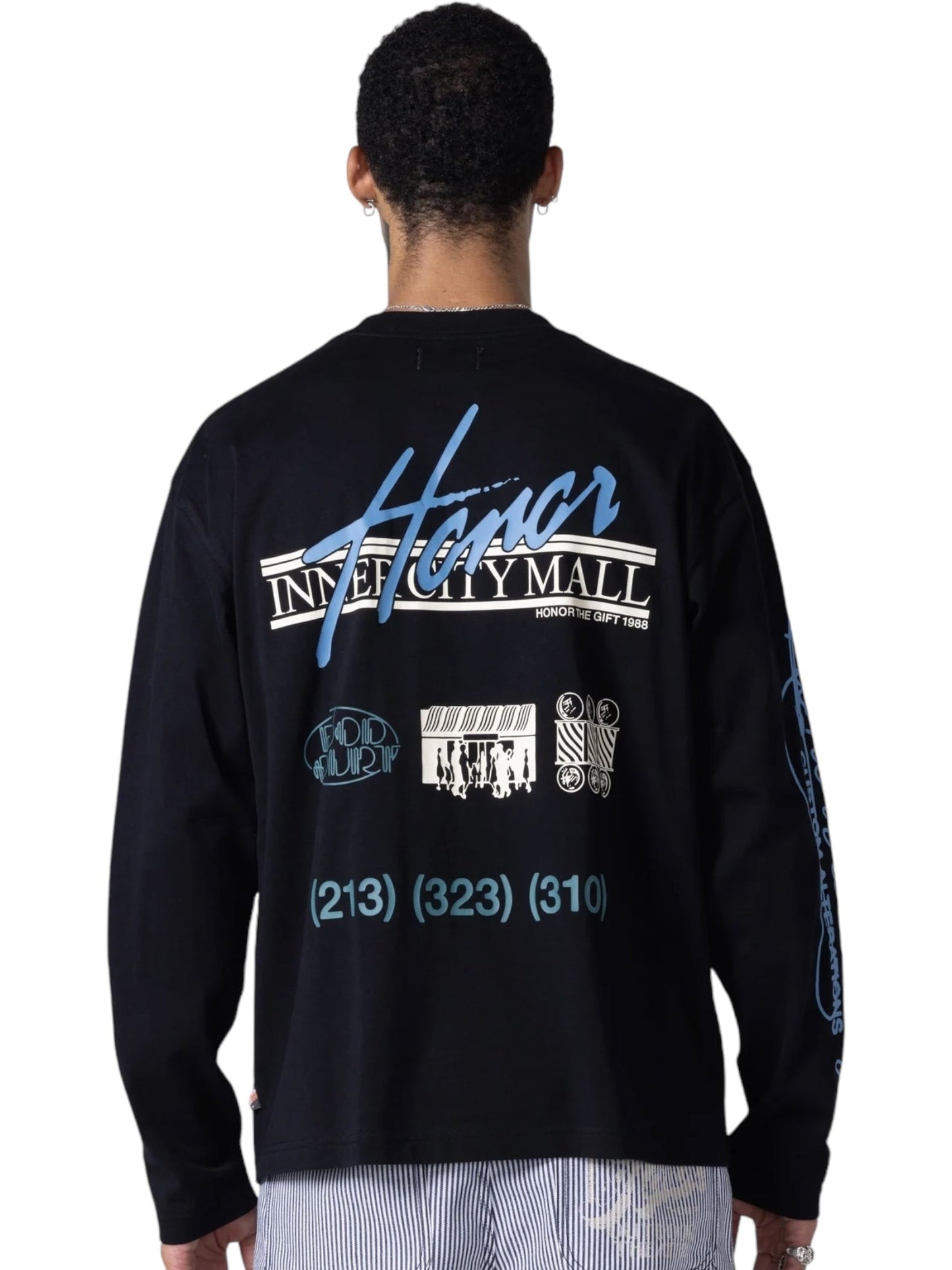 A person is seen from behind wearing the Honor The Gift Mall LS T-shirt in black by HONOR THE GIFT. Crafted from 100% cotton, it features white and blue mall logo graphics on a plain background.