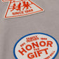 The Honor The Gift Multi Box Tee Stone features two embroidered patches—one triangular with "HONOR THE GIFT SINCE 1988" and human figures, and one oval with "HONOR THE GIFT" in red and blue on heavyweight cotton for lasting wear.