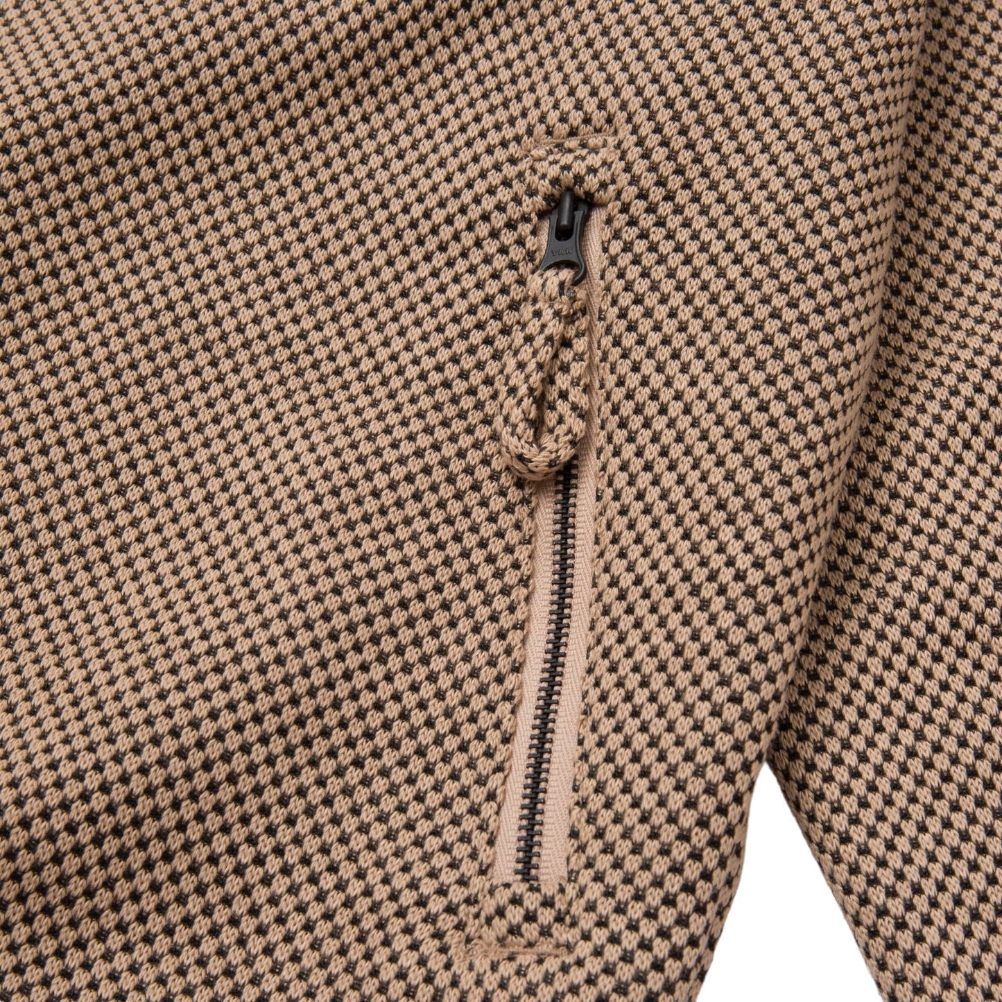 Close-up of the Honor The Gift Novelty Knit Track Jacket in brown by HONOR THE GIFT, showcasing its tan and black checkered fabric, zip front closure, and loop detail.