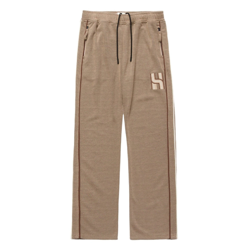 The Honor The Gift Novelty Knit Track Pant Brown, made by HONOR THE GIFT, features an elastic drawstring waist, zip closure side pockets, and a logo on the upper leg.