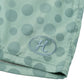 The HONOR THE GIFT Poka Dot Short Green features a light green polyester jacquard fabric with large polka dots, an embroidered "H" in an oval by the hem, and an adjustable drawstring for a perfect fit.