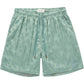 The HONOR THE GIFT Honor The Gift Poka Dot Short Green is crafted from soft polyester jacquard with an elastic waistband, adjustable drawstring, side pockets, and a small embroidered logo on the left leg.