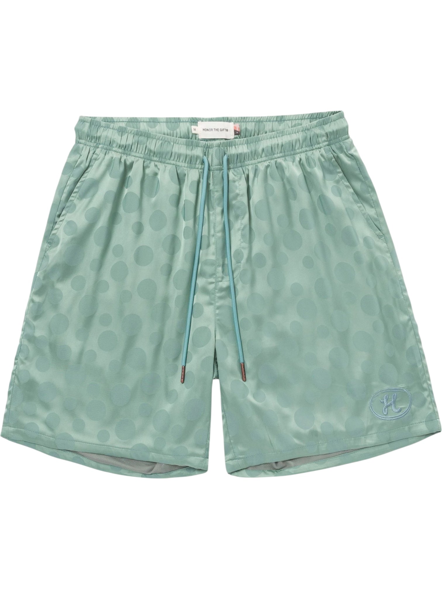 The HONOR THE GIFT Honor The Gift Poka Dot Short Green is crafted from soft polyester jacquard with an elastic waistband, adjustable drawstring, side pockets, and a small embroidered logo on the left leg.